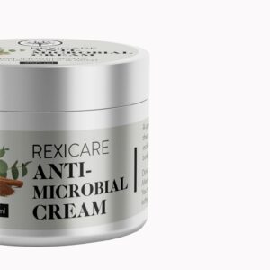 A partial view of a silver jar of REXICARE Anti-Microbial Cream with a white label, set against a plain white background.