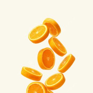 A pile of fresh orange slices, suspended in mid-air against a plain, light background.