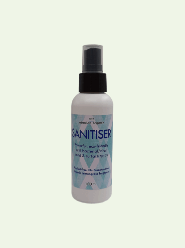 A white bottle of Absolute Organix Sanitiser with a spray nozzle and a label with a geometric pattern.