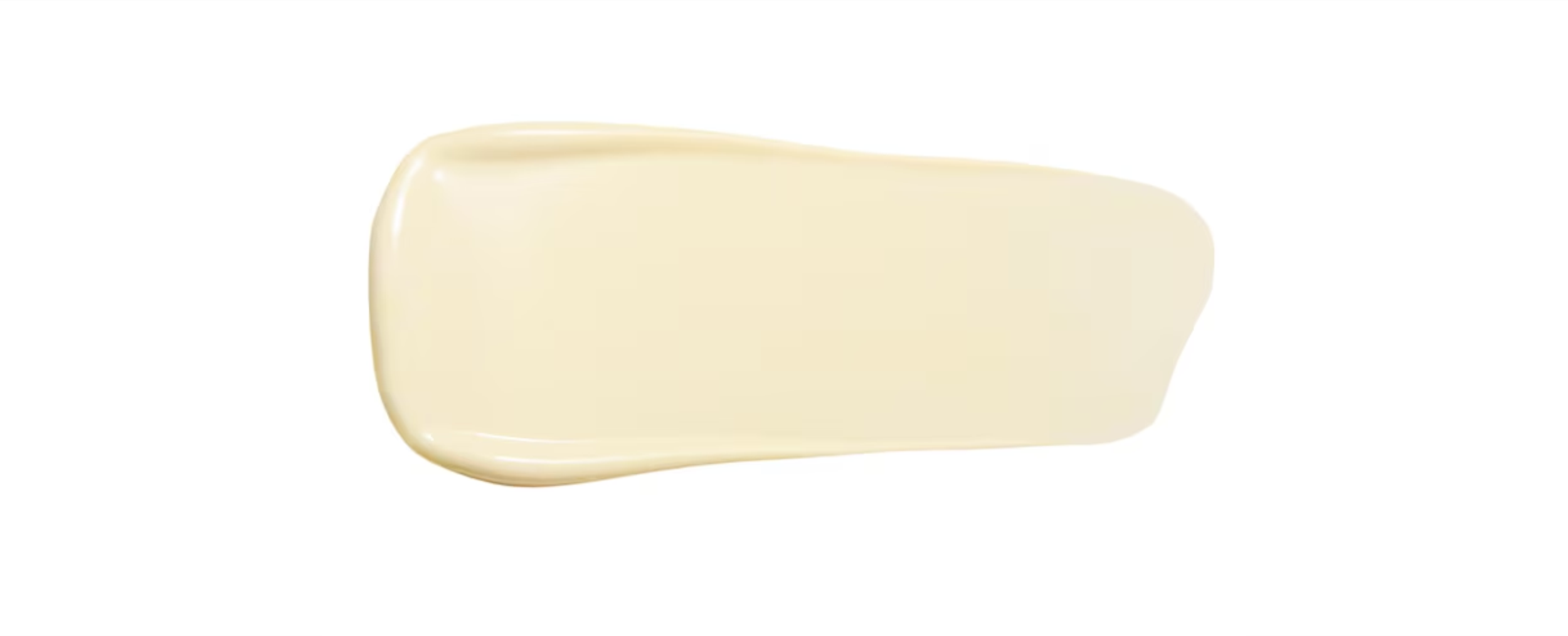 A smear of light yellow lotion or cream on a white background.