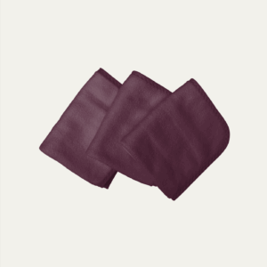 Three folded WOW Jude facecloths in a deep wine color.